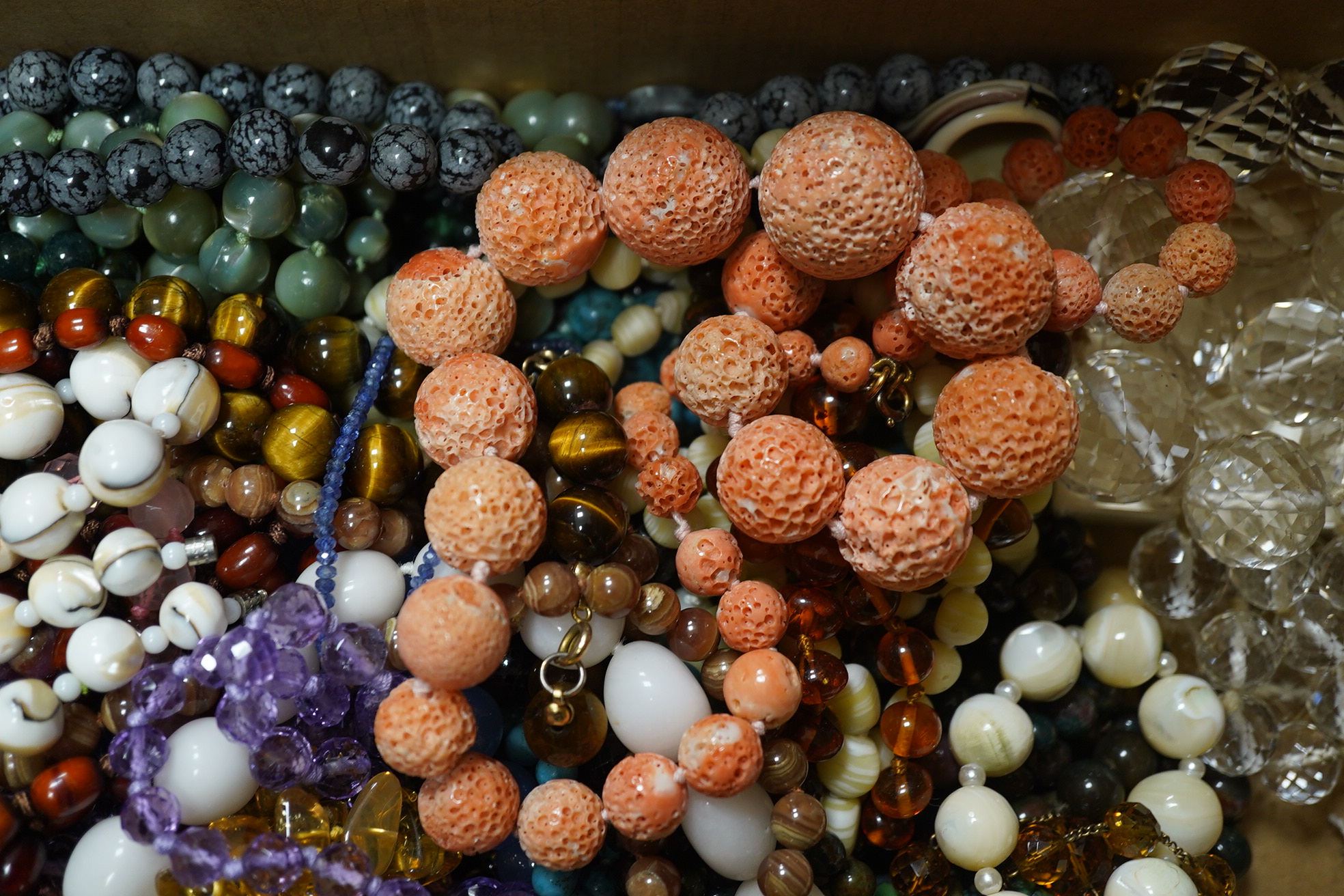 A quantity of assorted bead necklaces including, coral, various agates, turquoise cat's eye quartz, rock crystal, tiger's eye quartz, amethyst, aquamarine etc. Condition - poor to fair to good